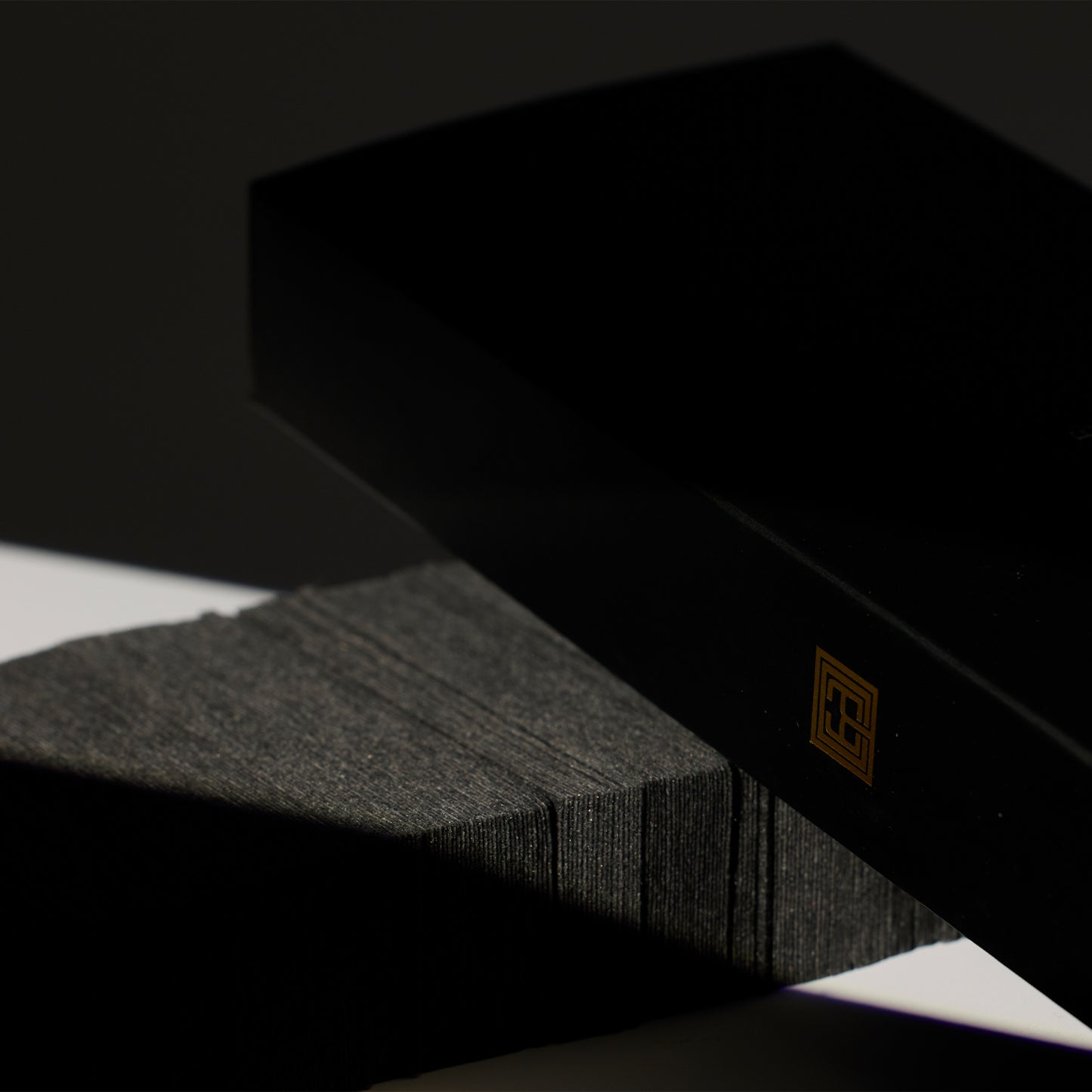 Close-up image of Brow Code's Pre-Cut Wax Strips packaging displayed beside a set of the pre-cut wax strips, showing both the product and its outer packaging
